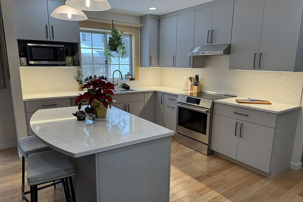 Kitchen features full height quartz backsplash that hides outlets and switches with quartz integrated covers.